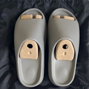 Brand new Gray Yeezy Slides from Yeezy.com. Size 11 men. Fits like 12. 30$